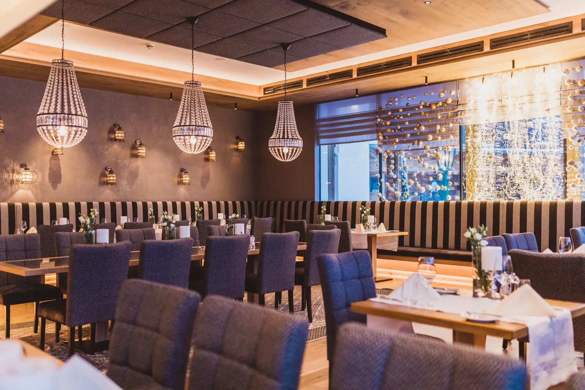 Elegant restaurant interior with tables set at the Greenvieh in Mieming, Tyrol
