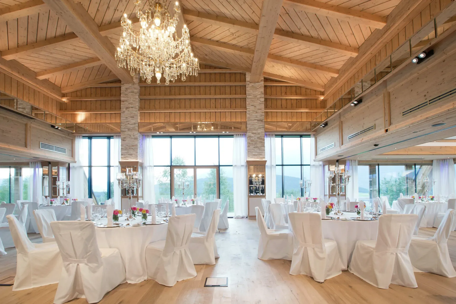 Grand ballroom with large crystal chandelier in the Greenvieh Chalet, Tyrol