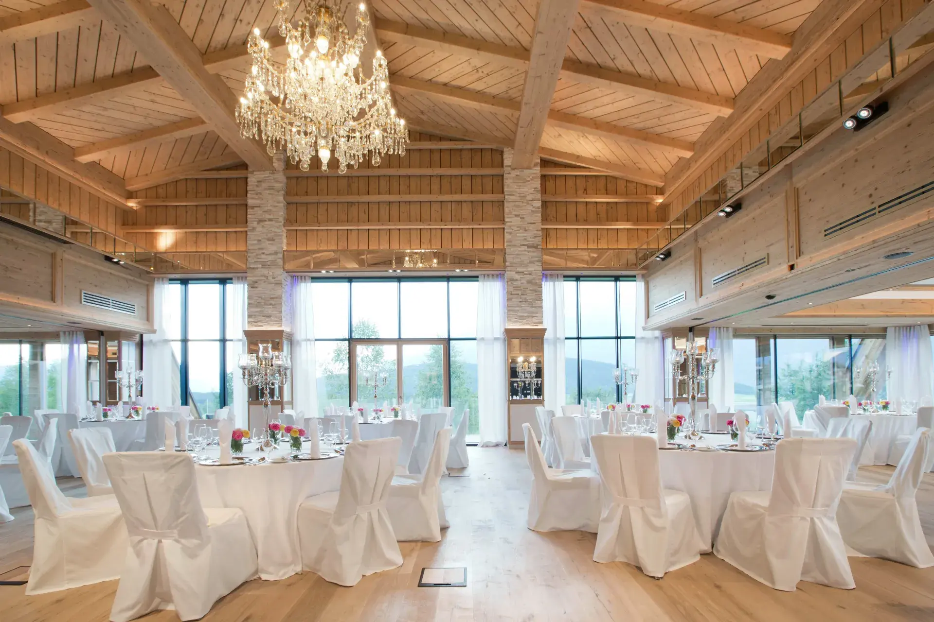 Festively set hall with chandelier in the Greenvieh Chalet in Mieming, Tyrol