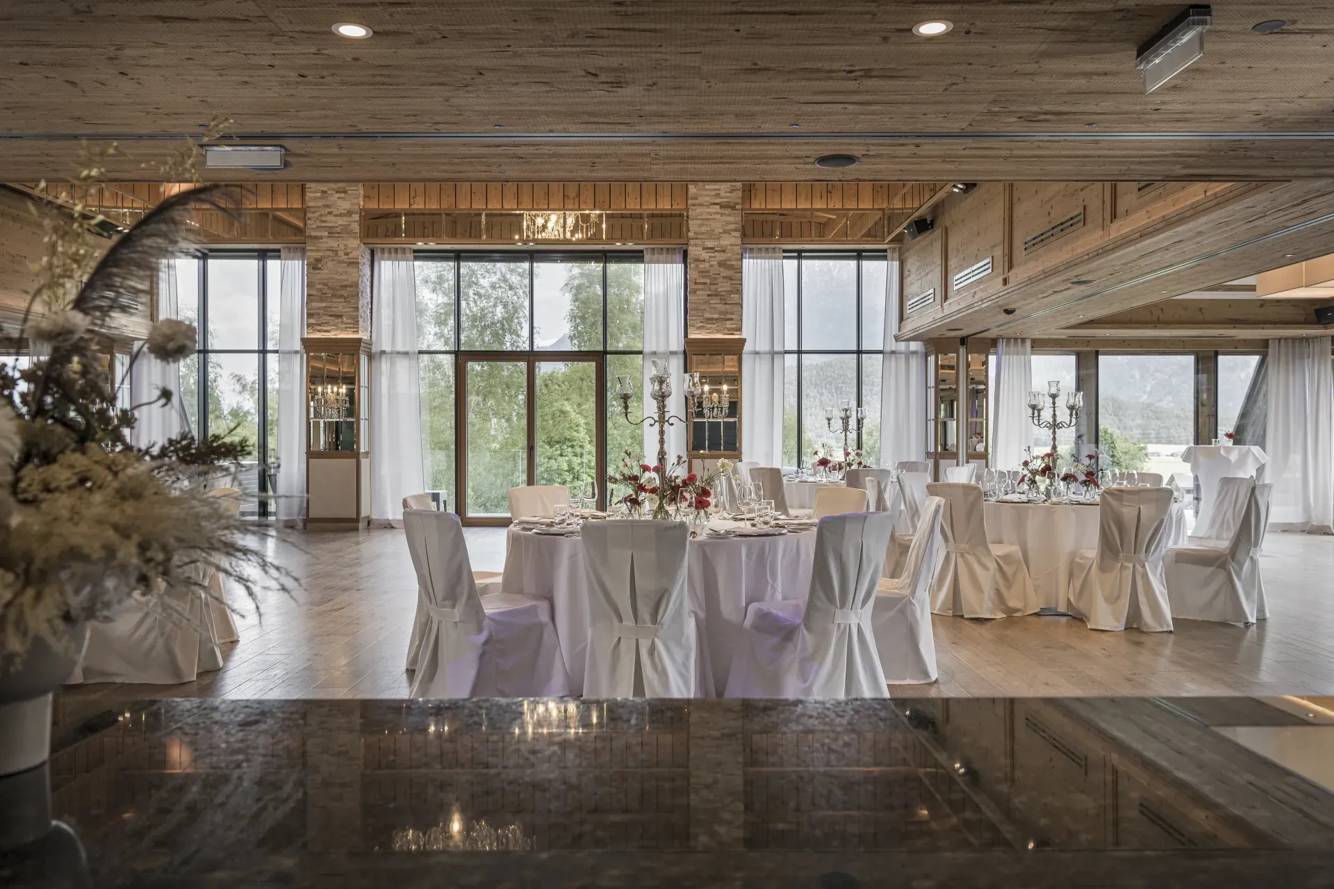 Elegantly set tables with chair covers in the Greenvieh Chalet ballroom