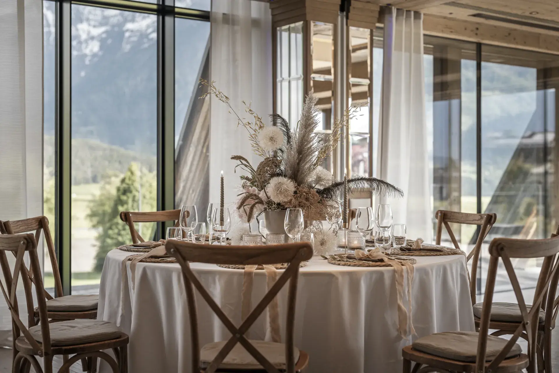 Festively decorated wedding table with dried flowers and mountain view at Greenvieh, Mieming